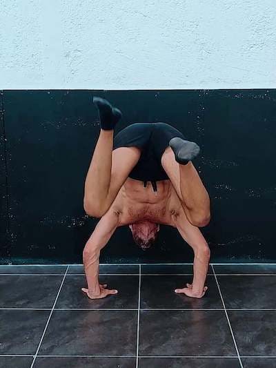 Negative wall assisted handstand to tucked planche